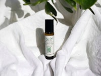 a bottle of essential oil on a white cloth